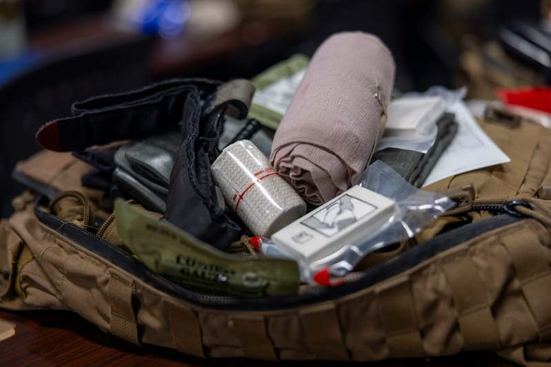 Flat lay of premium eyebrow tinting kit: tint gel, applicator brush, mixing tray, gloves, and before/after brow comparison chart on marble background